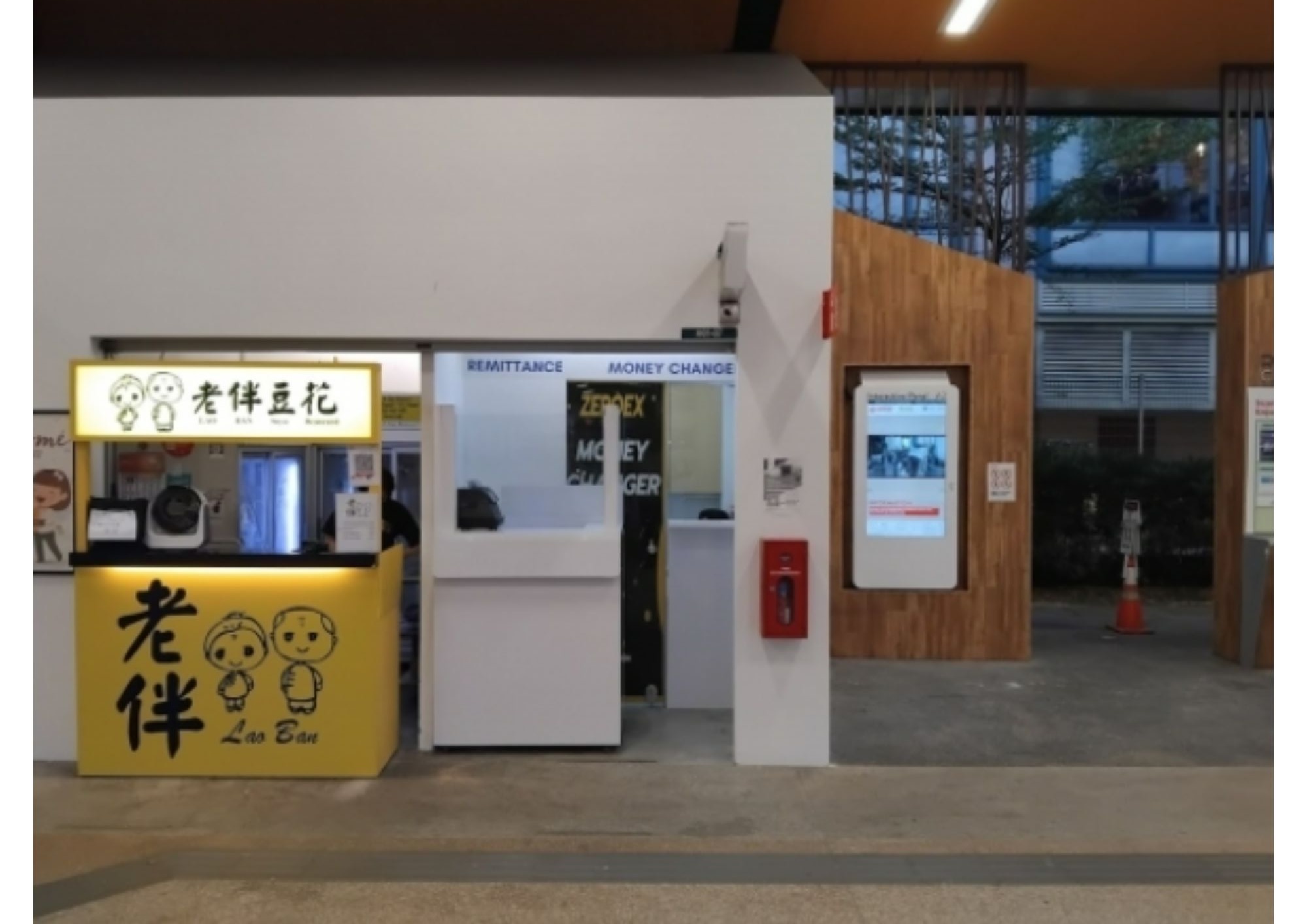 Zeroex Money Changer compact timber-clad kiosk at CCK Bus Interchange